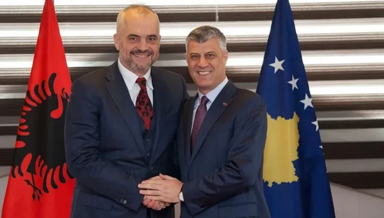 Albanian Prime Minister Edi Rama and then-President of Kosovo Hashim Thaçi shake hands and smile during an official meeting